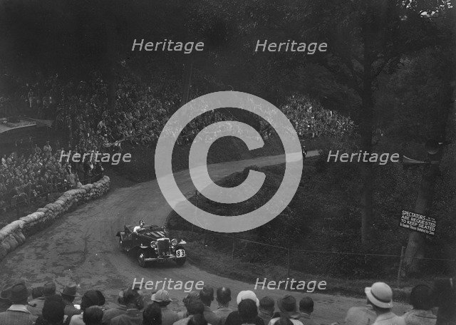 Unidentified open 4-seater car competing in the Shelsley Walsh Hillclimb, Worcestershire, 1935. Artist: Bill Brunell.