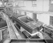 Motor launch in boatyard shed, 1913. Creator: Kirk & Sons of Cowes.