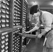 Woman looking through index cards, Medical Mailing Company, Ealing, London, 1960-1970. Artist: John Gay