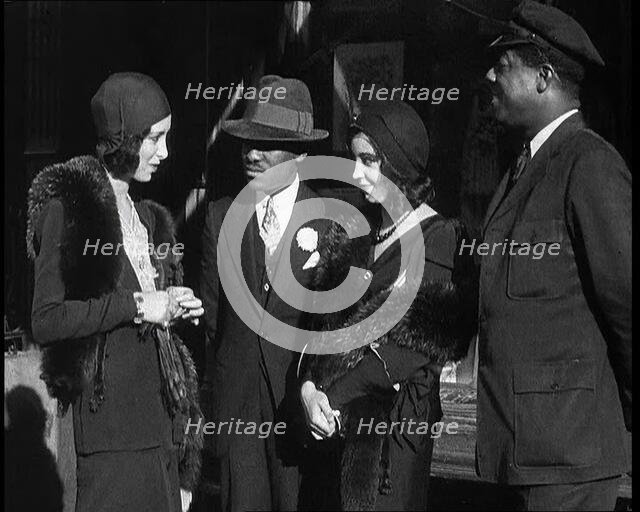 Smartly Dressed People in Conversation On the Streets of New York City, 1932. Creator: British Pathe Ltd.