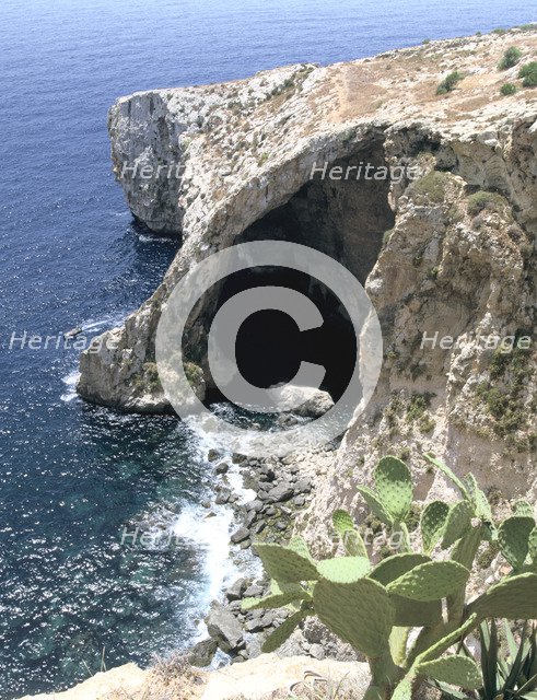 View of natural bridge and boat, Blue Grotto, Malta