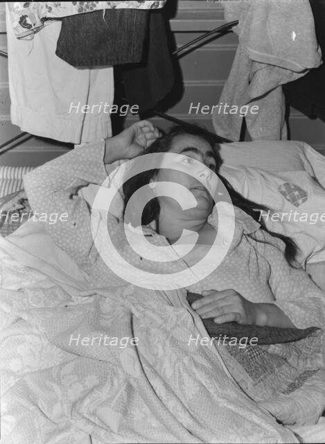 Sick woman in FSA camp for migratory agricultural workers, Tulare County, California, 1939. Creator: Dorothea Lange.