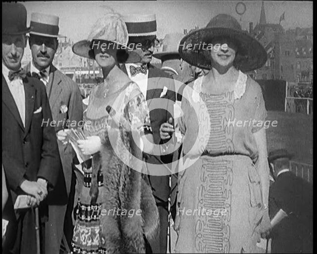 Civilians Wearing Smart Outfits and Hats Posing for the Camera During a Horse Race, 1920. Creator: British Pathe Ltd.
