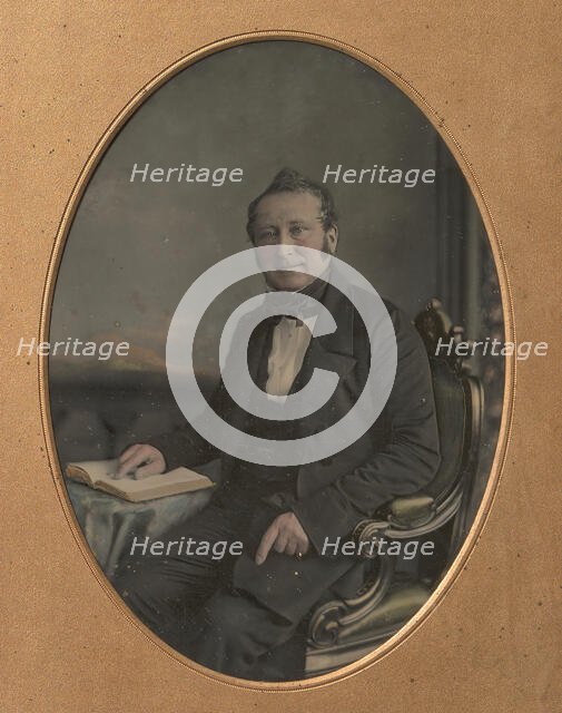 Seated Man Pointing to a Passage in an Open Book, 1850s. Creator: John Jabez Edwin Mayall.