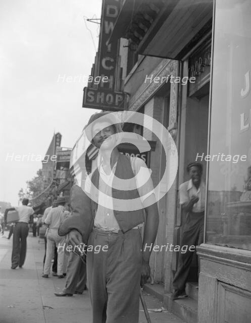 Panhandler on 7th Street, N.W., Washington, D.C., 1942. Creator: Gordon Parks.