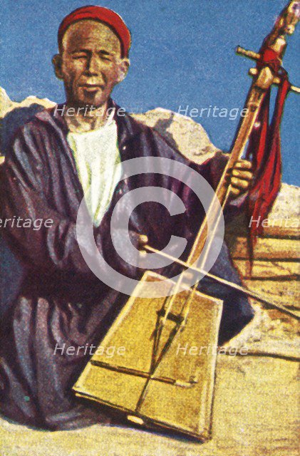 Itinerant musician, Mongolia, c1928. Creator: Unknown.