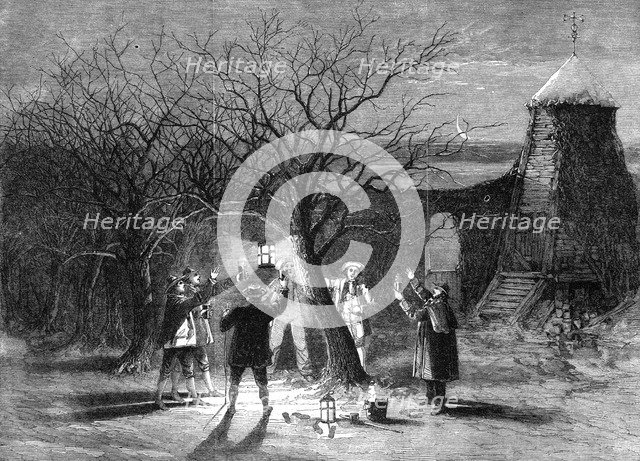 Wassailing apple trees with hot cider in Devonshire on twelfth eve, 1861. Artist: Unknown