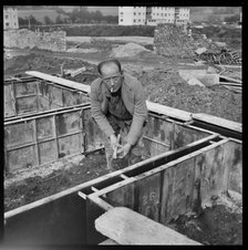 Builder working on the Penhill Estate, Swindon, Wiltshire, 1955. Creator: Unknown.