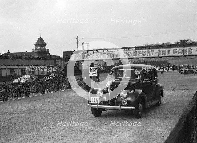 Ford V8 saloon competing in the JCC Rally, Brooklands, Surrey, 1939. Artist: Bill Brunell.