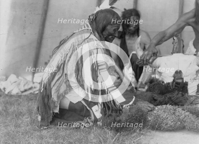 Saliva, Slow Bull (in background), Picket Pin's arm, c1907. Creator: Edward Sheriff Curtis.