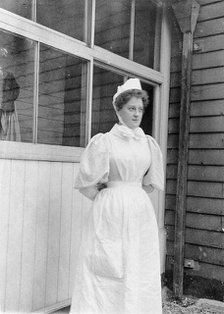 Nurse standing outside an isolation hospital, possibly at Ilford, Essex. Creator: Unknown.