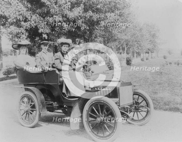 Frances Benjamin Johnston seated with three other people in automobile, between 1890 and 1910. Creator: Unknown.