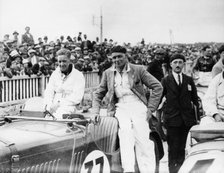 FS Barnes in the centre, AH Langley to his right, with a Singer Nine Sports car, 1930s. Artist: Unknown