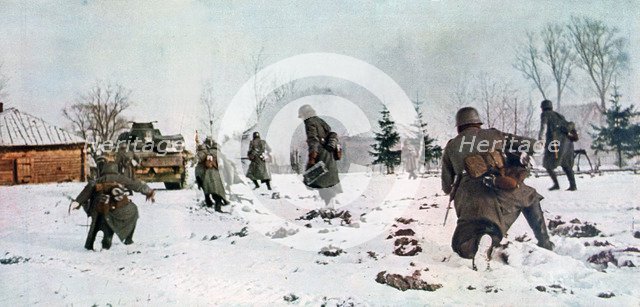 German infantrymen following a tank towards Moscow in the snow, Russia, 1941. Artist: Unknown