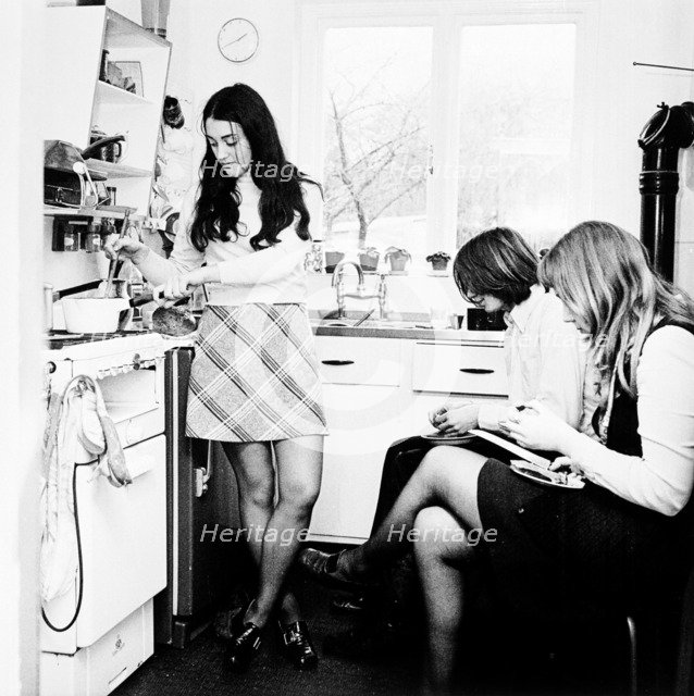 Three young people in the kitchen of a London flat, c1960s. Artist: Henry Grant