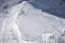 Ingleborough Iron Age univallate hillfort and hut circle earthworks in the snow, N Yorkshire, 2018. Creator: Emma Trevarthen.