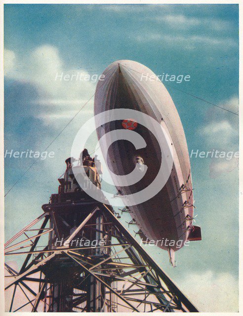 The US airship 'Macon' being moored to the mobile mast at Lakehurst, New Jersey, c1935 (c1937). Artist: Unknown.