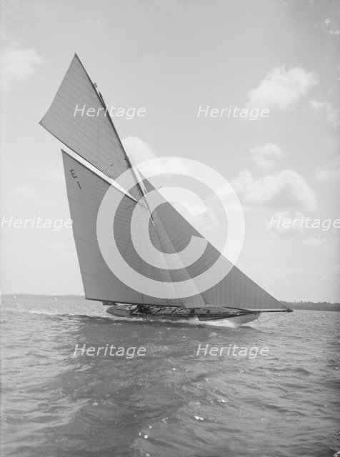 The 12 Metre yacht 'Alachie' makes swift progress upwind, 1911. Creator: Kirk & Sons of Cowes.
