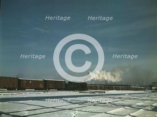 A train pulling out of the freight house at C & NW RR's Proviso(?) yard, Chicago, Ill., 1942. Creator: Jack Delano.