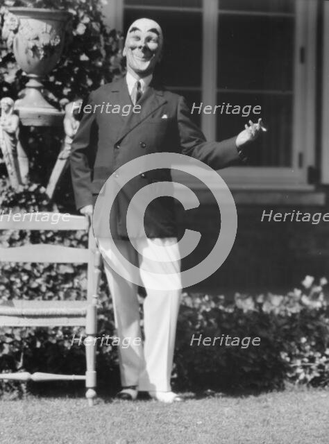 Person wearing a mask made by W.T. Benda, 1925 Sept. 20. Creator: Arnold Genthe.