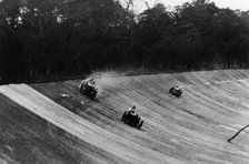 Louis Zborowski passing Humphrey Cook's Ballot by skidding above him, Brooklands. Artist: Unknown