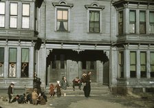 Children with adult in the tenement district, Brockton, Massachusetts, 1940. Creator: Jack Delano.