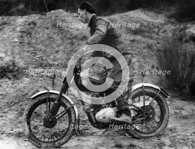 Cullen riding a Francis Barnett bike at the J White Trial. Artist: Unknown