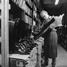 The interior of the workshop where Mr Eric Lobb is at work on a boot, London, c1946-c1959. Artist: John Gay