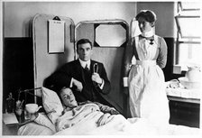Charing Cross Hospital: Basil Hood with patient, 1904. Creator: Unknown.