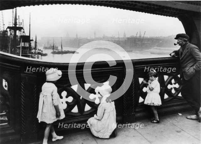 People watching the Thames from Tower Bridge, City of London, c1930. Artist: George Davison Reid