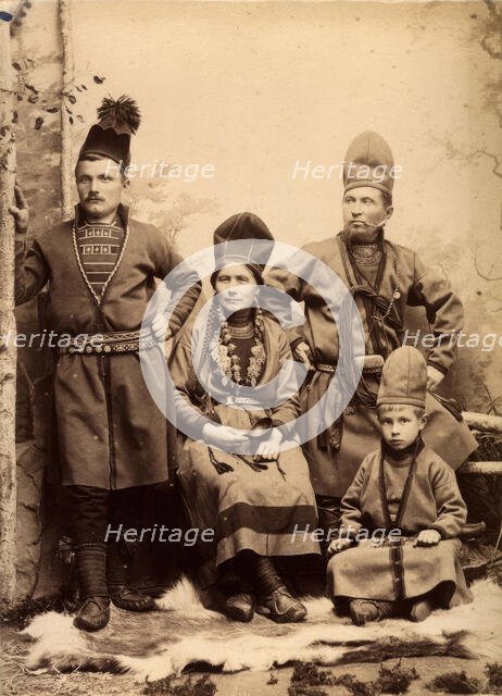 Group picture with four people wearing Sami folk costumes, 1912.  Creator: Helene Edlund.