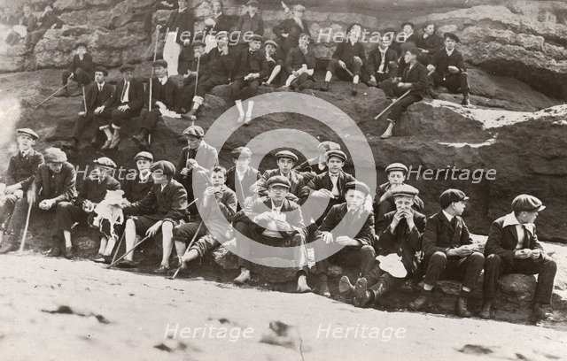 Rowntree boys on an outing sit on a rocky outcrop ,Filey Brig, Yorkshire, June 1911. Artist: Unknown