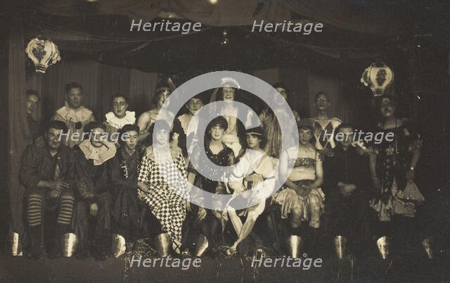 An ensemble cast of British soldiers, some in drag, pose on stage, 1919. Creator: Unknown.