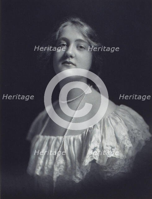 Young woman wearing an off-the-shoulder dress and long pearl necklace, looking front..., c1900. Creator: F. Gercher.