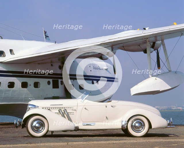 1935 Auburn 851 speedster with Sunderland flying boat. Artist: Unknown.