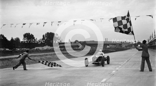 Alfa Romeo taking the chequred flag in a race at Brooklands. Artist: Bill Brunell.