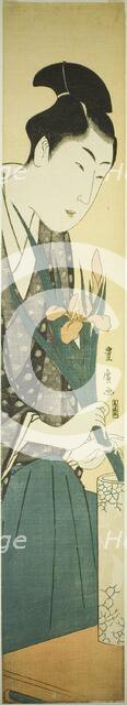 Young man arranging irises in a vase, n.d. Creator: Utagawa Toyohiro.