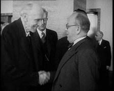 Two Male League of Nations Delegates Greeting Each Other By Shaking Hands While Two Other..., 1937. Creator: British Pathe Ltd.