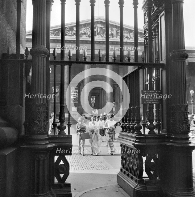 Three young women walk towards the exit gateway of the British Museum, Camden, London, c1946-c1959. Artist: John Gay