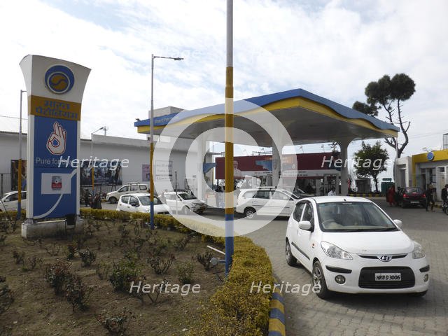 Cars re-fuelling at petrol station Dharamshala Himachal Pradesh. Creator: Unknown.