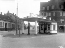 A  Texaco petrol pump in a built-up area, Landskrona, Sweden, 1930 Artist: Unknown