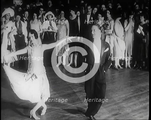 Female Civilian and Male Civilian Dancing in Front of a Crowd of People, 1926. Creator: British Pathe Ltd.
