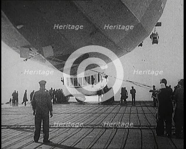 Airship Approaching an Aircraft Carrier And Attempting To Land, 1920s. Creator: British Pathe Ltd.
