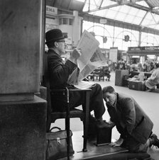 Shoeblack at Waterloo Station, London, 1962-1964. Artist: John Gay