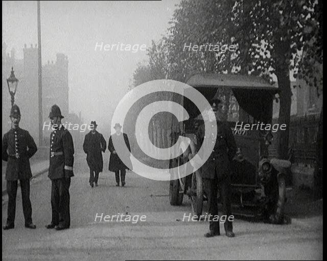 Two Vicars Walking Past Policemen Outside Brixton Prison, 1920. Creator: British Pathe Ltd.