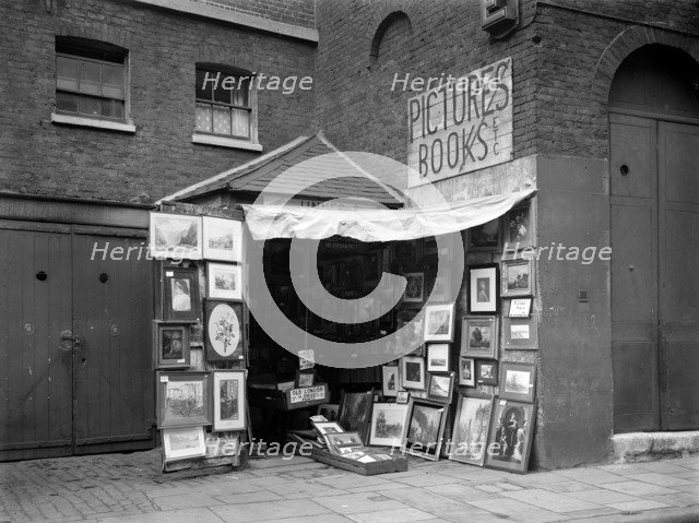 Framed pictures displayed outside a second hand book and picture shop, London, 1933.  Artist: WA Clark
