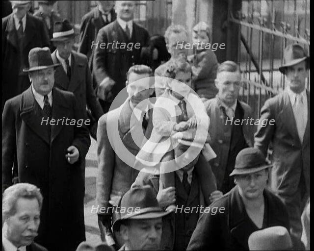 Crowd Walking Down a Pavement, 1930s. Creator: British Pathe Ltd.