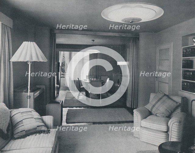 'Dining and living room, divided only by heavy curtains in an attractive modern weave', 1942. Artist: Unknown.