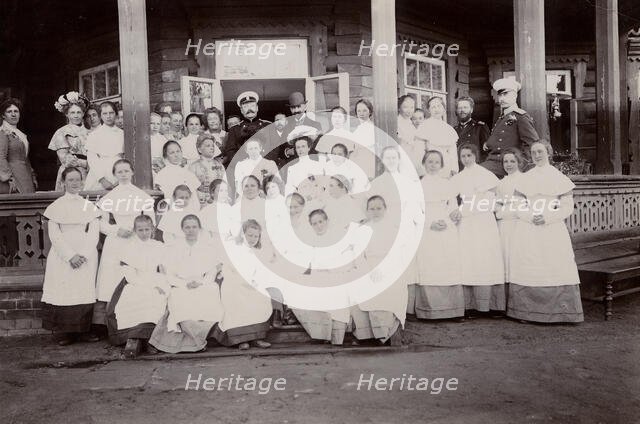 A group of students from the Maiden Institute with teachers on the porch of the dacha, 1900. Creators: I. A. Podgorbunskii, V. I. Podgorbunskii.