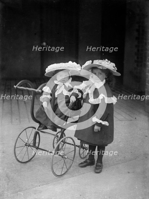 Two children and a pram, c1896-c1920. Artist: Alfred Newton & Sons